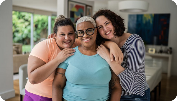 Three women smiling together at home