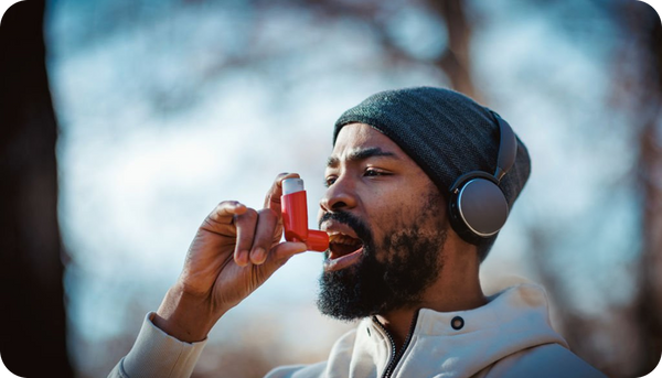 A man using an asthma inhaler